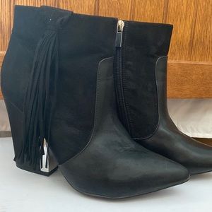 Booties with tassels ad silver heel edging.